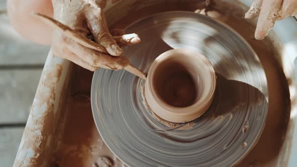 Potter Shapes the Clay Product with Pottery Tools on the Potter's Wheel, Top View, Craft Factory alt