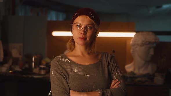 Female Sculptor in Dim Studio alt