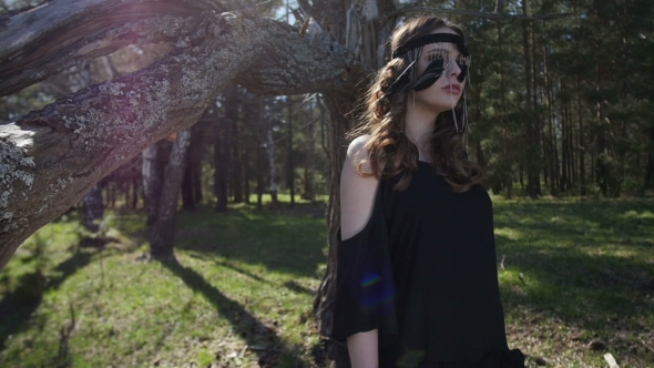 Beautiful Girl In a Black Dress Walks In The Woods