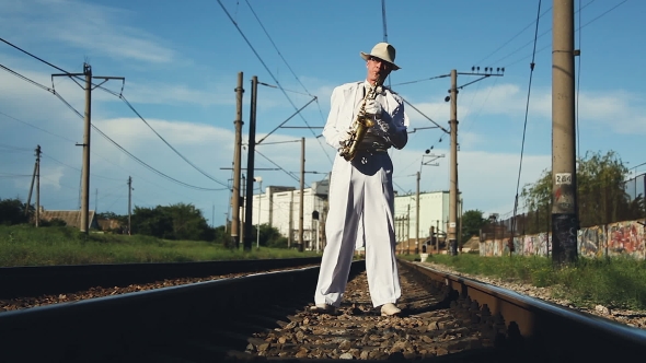 Saxophonist, Male, Middle-aged Man Standing On The Railway Sleepers. Series.
