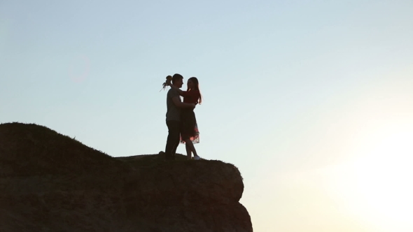 Guy And Girl In The Sunlight On The Hill Above The Sun.