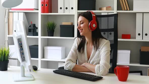 Businesswoman Listening Music Looking To Monitor and Smiling