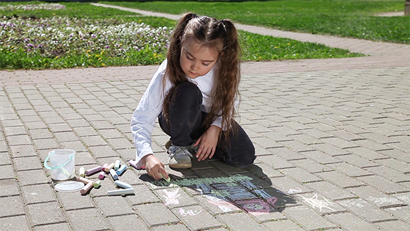 Little Girl Drawing on Pavement With Chalk 
