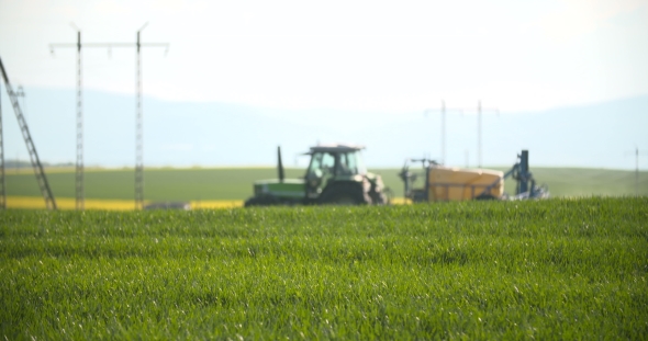 Tractor Spray Fertilize On Field With Chemicals In Agriculture Field. alt