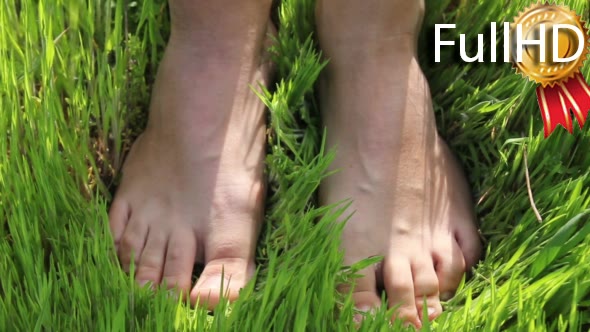 Woman Walking Barefoot on the Grass