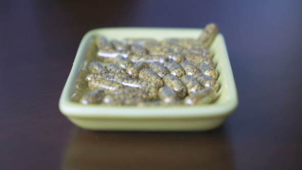 Tablets Are Scattered In a Container On The Table