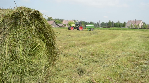  Of Hay Bale And Blurred Machine Tractor Collect Straw