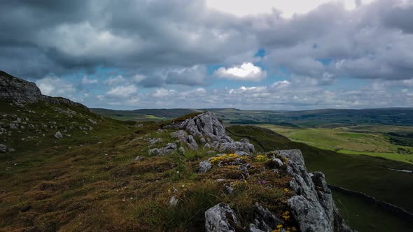 Time-lapse panning shot looking over the upper Eden Valley Cumbria with fasting clouds casting their alt