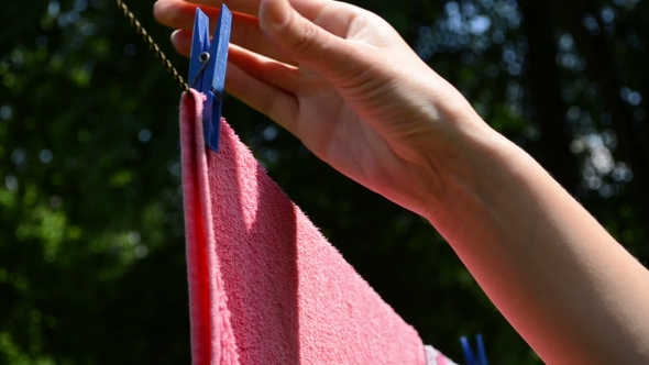 Hand Put Pins Clips On Drying Laundry Hang On Clothesline