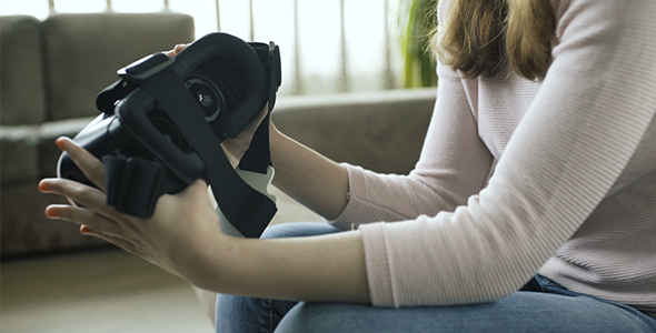 Girl Looking Over Virtual Reality Headset