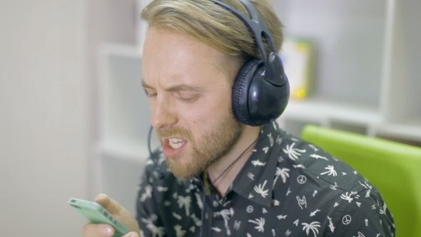 A Young Man Is Listening To Music alt