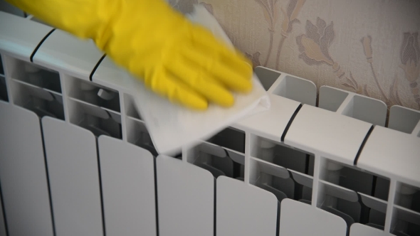 Female Hand In  Rubber Glove Cleans Heating Radiator