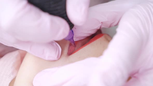 Microblading Lip Tattooing with a Special Red Pigment That Corrects Lip Color in a Cosmetology alt