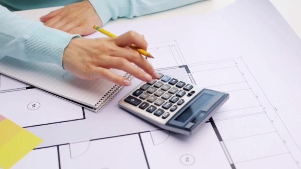Woman With Blueprint Counting On Calculator 55 alt