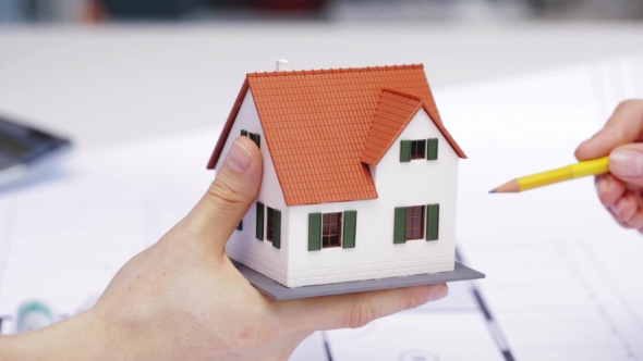 Woman And Architect Discussing Model Of House 113 alt