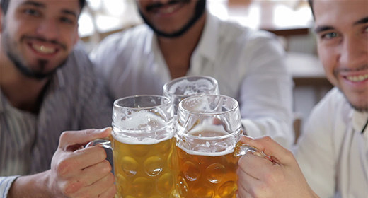 Friends having fun together in the bar with a beer