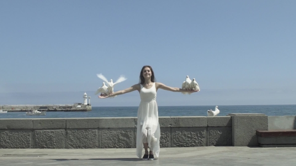 Happy Woman Releasing A Pigeons