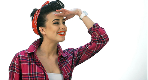 Beautiful young woman with pin-up make-up and hairstyle posing