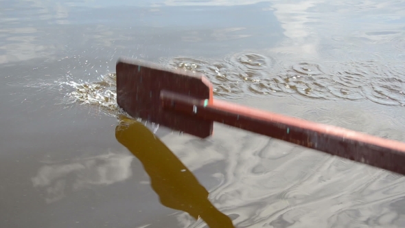 Old Wooden Paddle Bounces Into Lake Water 