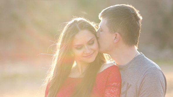 Beautiful Young Couple In Love Kiss In The Sun