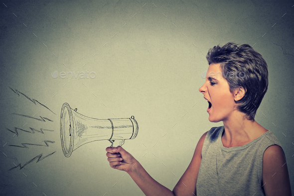 angry young woman screaming with megaphone