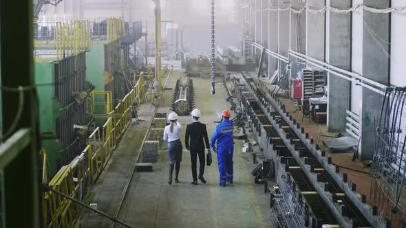 Crew foreman explaining senior executives factory plan