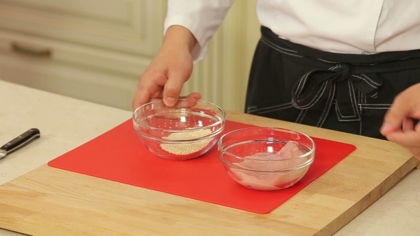 Raw Piece of Chicken Breast in Sesame Breading
