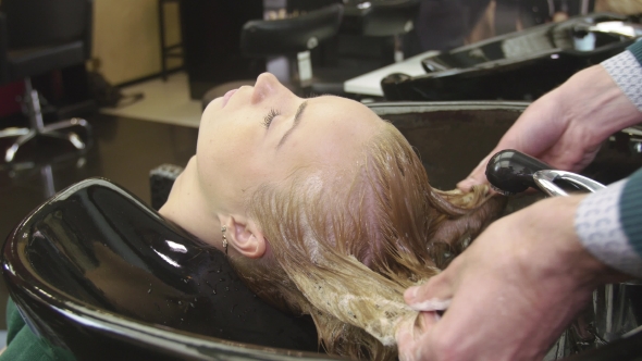 Professional Barber Rub Shampoo In Hair Of Blonde Young Girl alt