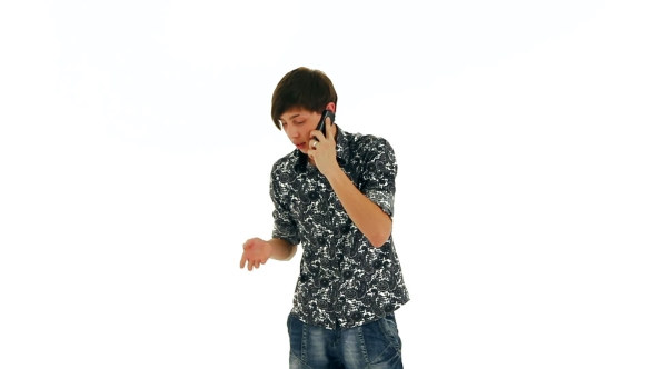 Young Man Emotionally Talking On Phone