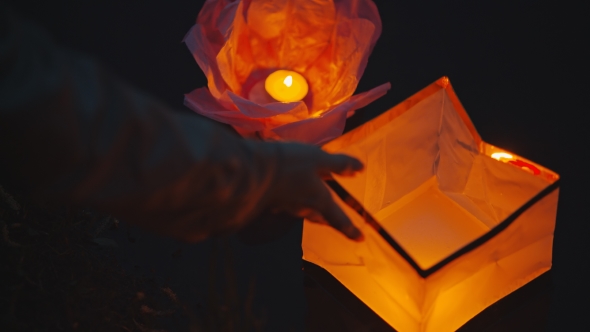 People Go Into The Water a Glowing Paper Lantern
