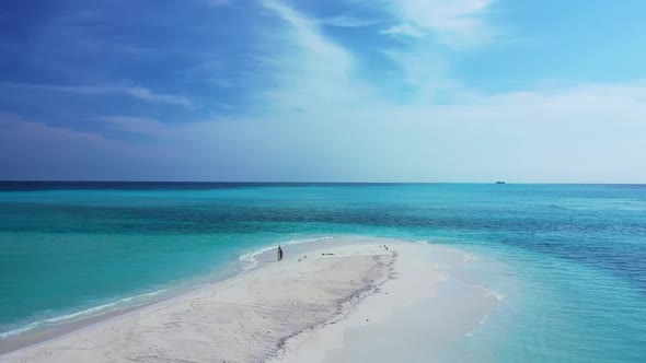 Aerial drone shot landscape of marine lagoon beach break by shallow ocean with clean sandy backgroun alt