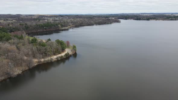 Aerial view over Mississippi River in autumn. Mountains and clouds in sky in distance.