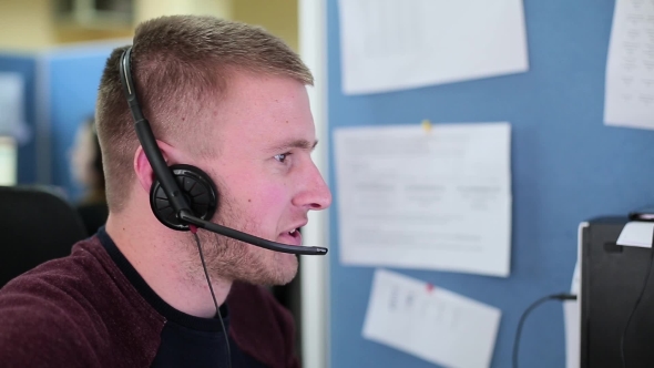 Man Talking With a Client In a Call Center