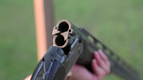 Man Inserts Bullets In The Gun