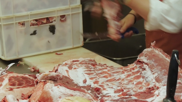 Butcher Cuts a Fresh Raw Meat