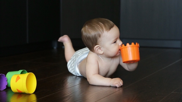 Happy Baby Playing With a Pyramid alt