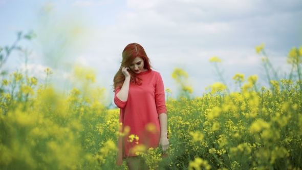 Girl With Bouquet Of Rape Blossom In The Field, Wind Blowing, Cloudy Sky  alt