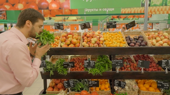 Man Selecting Fresh Mint In Grocery Store.