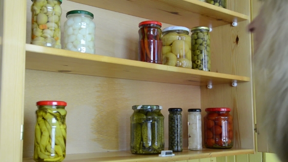 Housewife Puts On The Shelves Canned Marinated Vegetables Jars