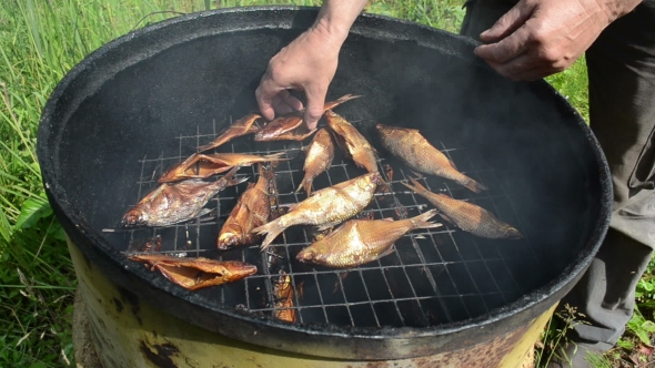 Man Hand Take Fresh Delicacy Smoked Fish From Smokehouse