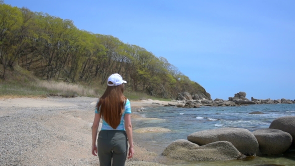 Girl Walking On The Beach