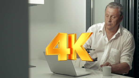 Serious Adult Man Working On Laptop While Drinking Coffee In Kitchen alt
