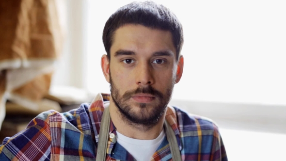 Workman In Checkered Shirt And Apron At Workshop 12 alt