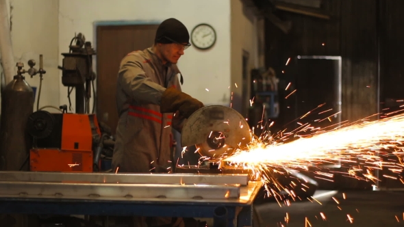 Manual Worker In Steel Factory Circular Blade On Piece Of Metal