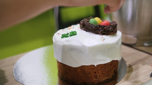 Female Hands Decorating Homemade Easter Cake alt