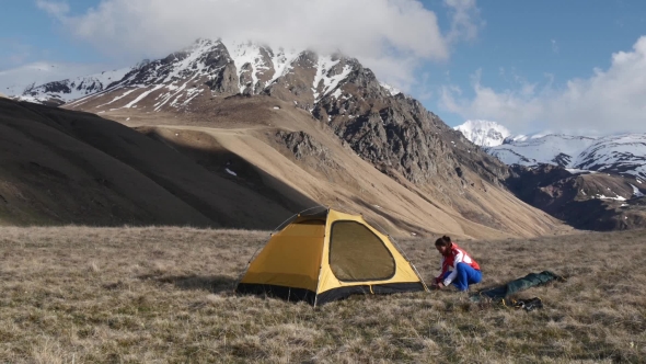 Woman Setup a Tent In The Mountains alt
