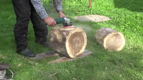 Man Hand With Electric Sander Tool Sand Wood Oak Tree Log