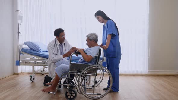 Doctor and physiotherapist caring for patient in ward alt