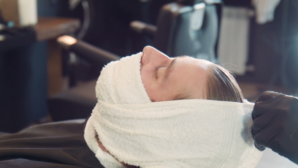 Barber Wrapping Man's Beard In Hot Towel alt