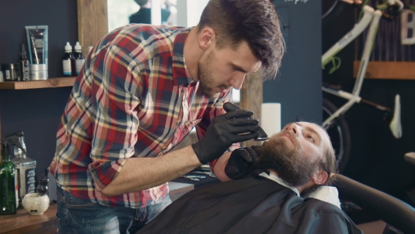 Barber Trimming Man's Beard alt